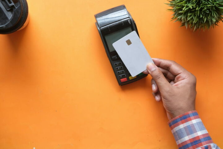 The picture showing a person paying for service, illustrating the article about German retail payment trends 2026 describing trends that will happen at the end of 2026 and a little about a 2027